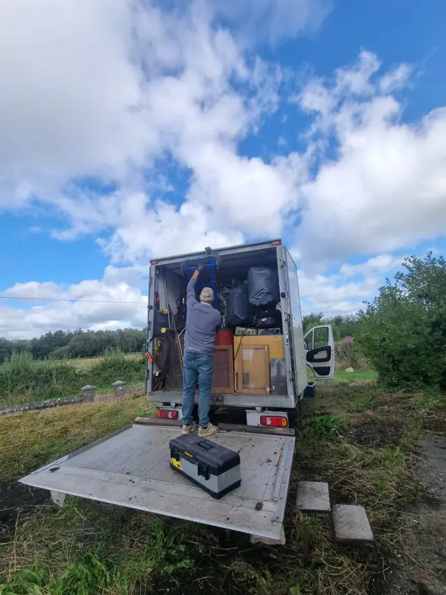Crew member loading a truck during a junk removal